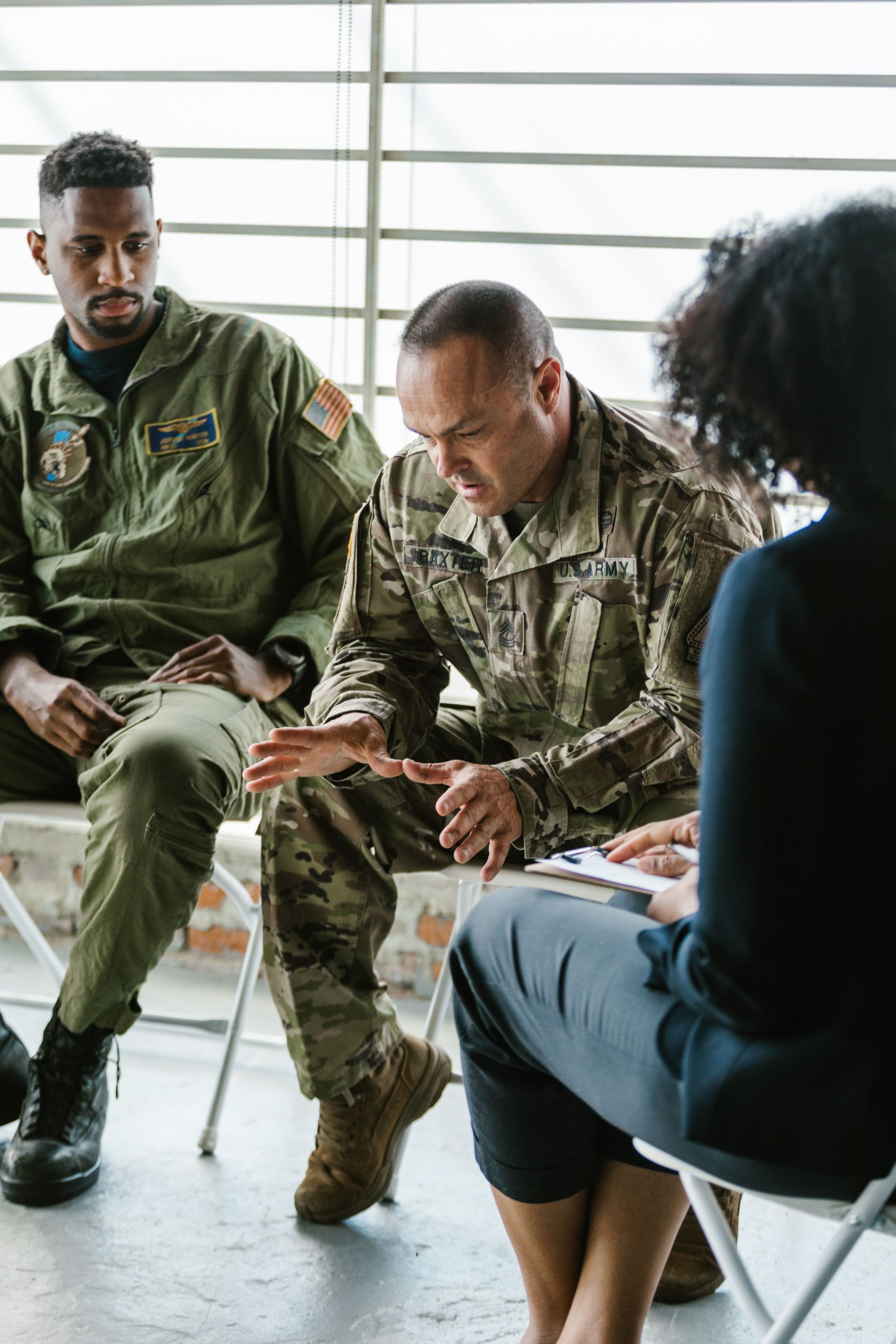 Veterans participate in a group therapy session focusing on mental health and support.